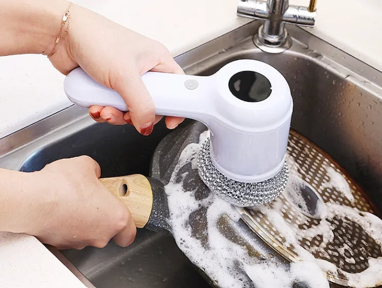 TurboScrub with the steel wool head cleaning a pan in a soapy kitchen sink